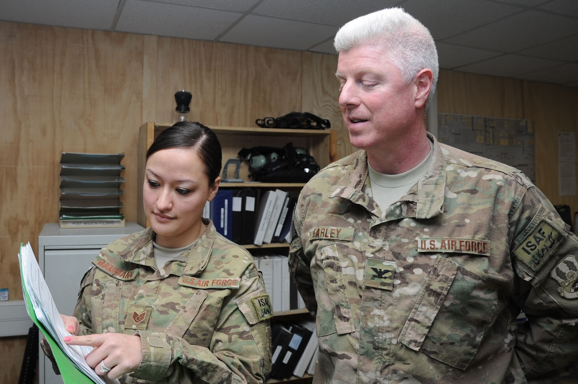 Staff Sgt. Donna Baumann, 455th Expeditionary Aeromedical Evacuation Squadron aviation resource manager, briefs Col. Edward Farley, 455th EAES commander, on a flight authorization Feb. 15, 2013, on Bagram Airfield, Afghanistan. Baumann is the only aviation resource manager in the squadron and is indispensable for getting patients the right clearances to travel on aircraft. (U.S. Air Force photo/Staff Sgt. David Dobrydney)