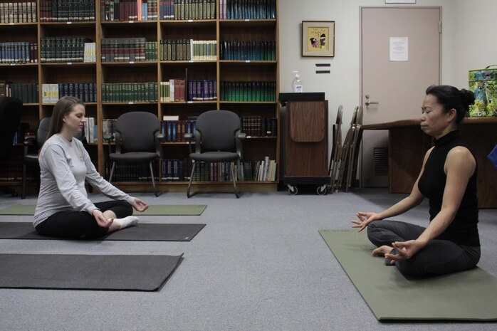 Prakai Parsons (right), IronWorks yoga instructor, and Katie Bayley (left), station resident and mother-to-be, practice meditation during a pre-natal yoga class at the Baby Expo here, Jan. 26, 2013. Some of the classes provided included budgeting for a baby, nutrition for moms and several classes on baby health. The event’s target audience was mainly those expecting a baby and young families planning to have a baby.