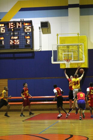 A Headquarters and Headquarters Squadron Air Traffic Controller Intramural Basketball team member attempts a lay-up Jan. 31, 2013, at the IronWorks sports courts here. The H&HS ATC team went on to win the night’s game with a score of 48-25.