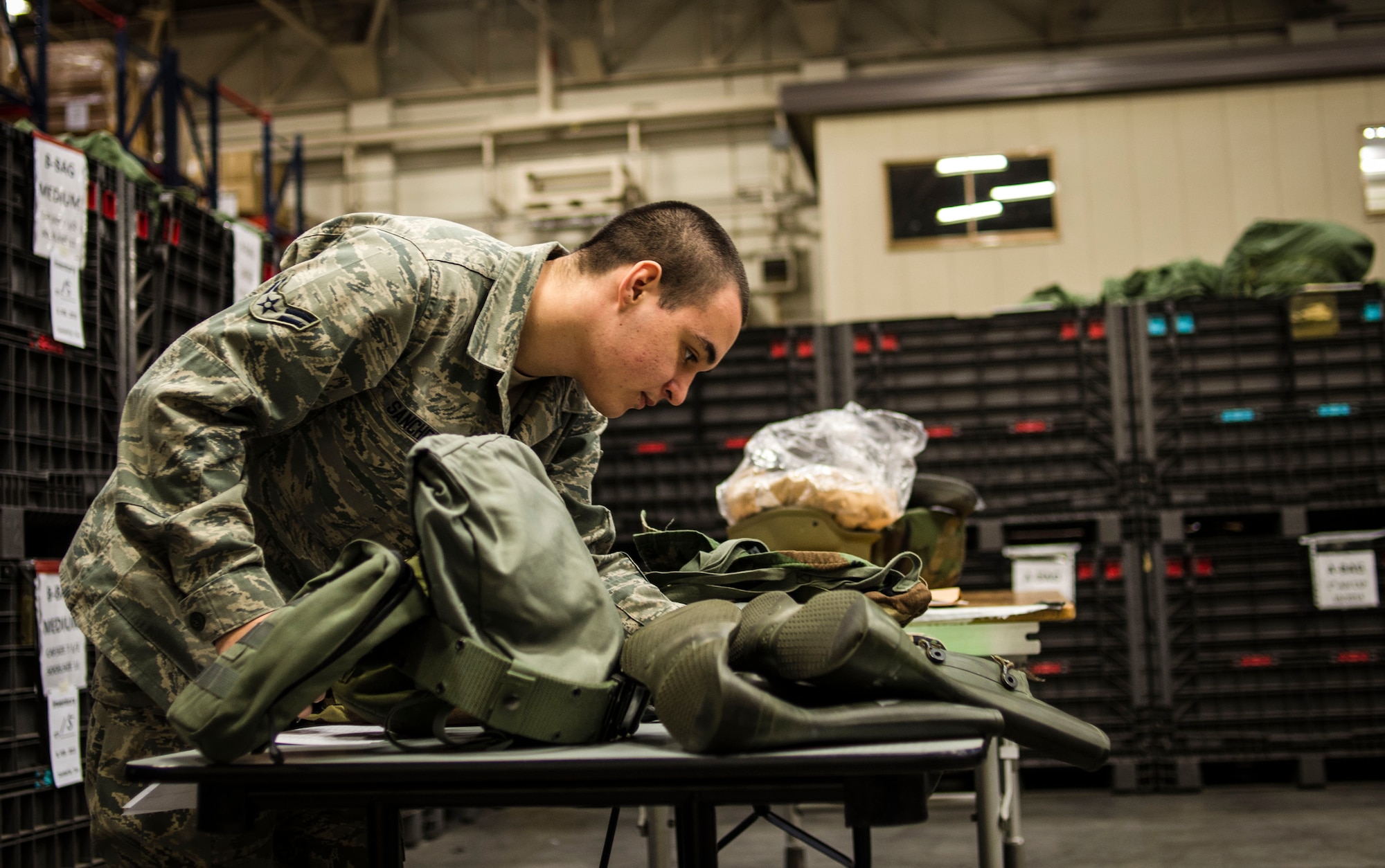 Airman 1st Class Angel Sanchez, 374th Logistics Readiness Squadron individual protective equipment technician, fills out paperwork during a gear inventory and helmet issue at Yokota Air Base, Japan, Feb. 15, 2013. 374 LRS Airmen provide IPE gear to Yokota Airmen in order to improve the safety and readiness of Yokota.  (U.S. Air Force photo by Capt. Raymond Geoffroy)