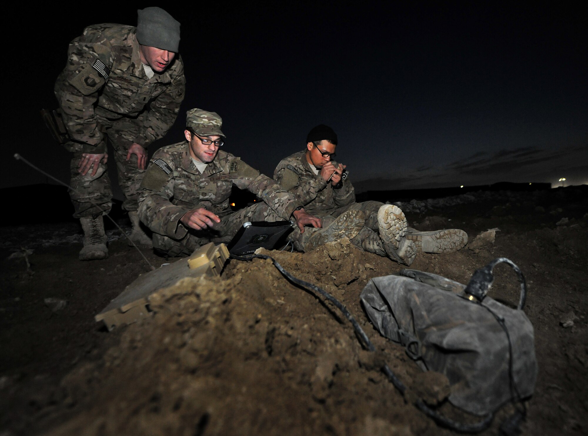 1st Lt. Joshua Loomis, Tech. Sgt. John Dolbee, and Staff Sgt. Ben DeSantiago, 755th Expeditionary Security Forces Squadron Reaper team trackers, monitor enemy movement and detection sensors at Bagram Airfield, Afghanistan, Feb. 14, 2013. The team uses a series of search techniques from simple eyes-on to ground sensors to track insurgent activity and provide site exploitation after an attack. (U.S. Air Force photo/Senior Airman Chris Willis)