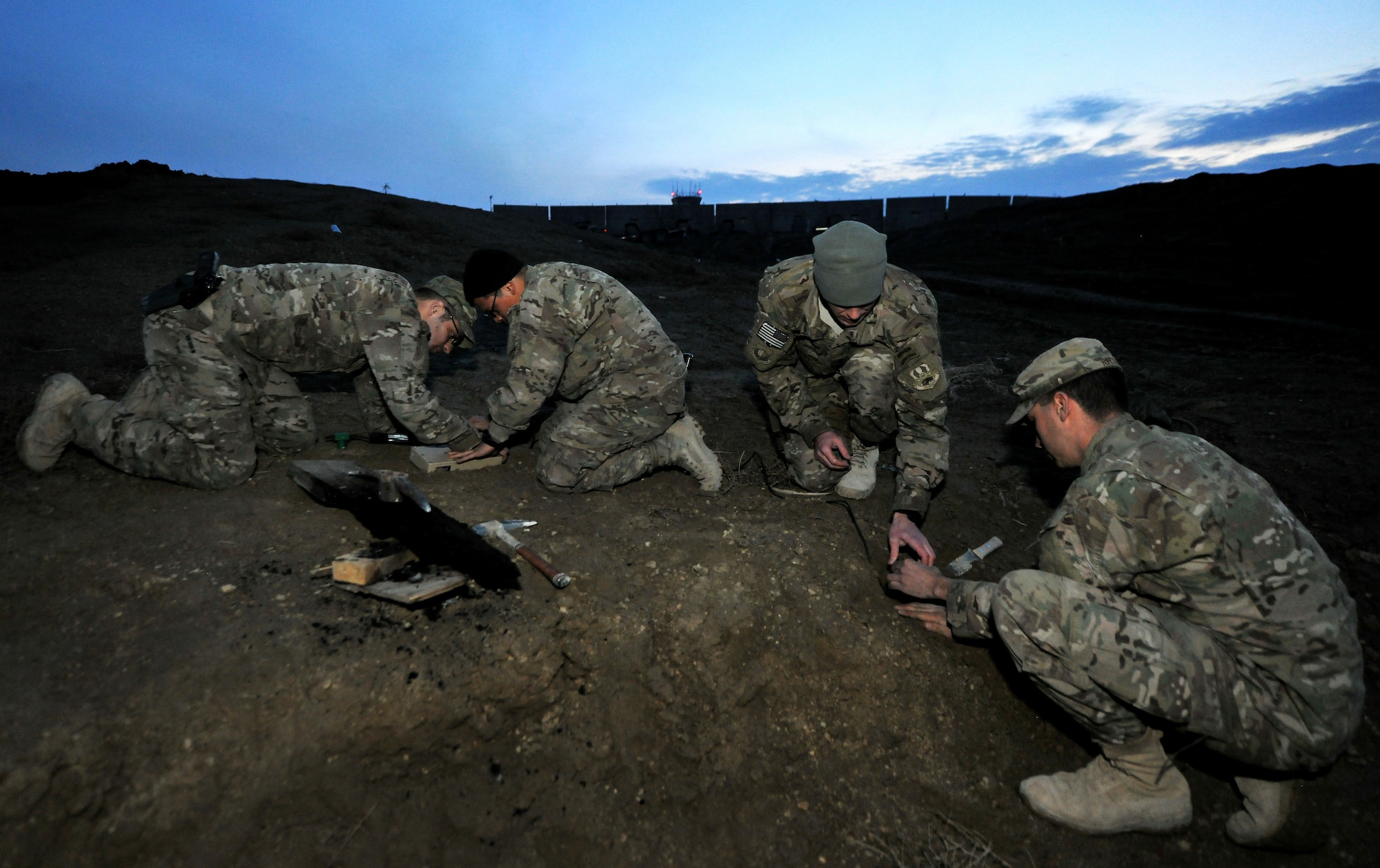Tech. Sgt. John Dolbee, Staff Sgt. Ben De Santiago, 1st Lt. Joshua Loomis, and Staff Sgt. Craig Ritter, 755th Expeditionary Security Forces Squadron Reaper team trackers, emplace ground sensors for an enemy movement and detection training scenario at Bagram Airfield, Afghanistan, Feb. 14, 2013. The tracker team members are all deployed from the 822nd Base Defense Squadron, Moody Air Force Base, Ga. (U.S. Air Force photo/Senior Airman Chris Willis)