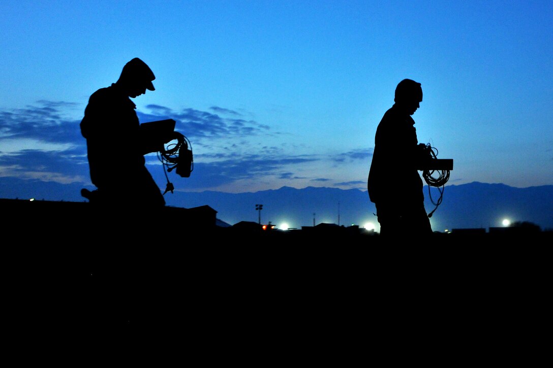 Staff Sgt. Craig Ritter and 1st Lt. Joshua Loomis, 755th Expeditionary Security Forces Squadron Reaper team trackers, move into position to place ground sensors for an enemy movement and detection training scenario at Bagram Airfield, Afghanistan, Feb. 14, 2013. The team uses a series of search techniques from simple eyes-on to ground sensors to track insurgent activity and provide site exploitation after an attack. (U.S. Air Force photo/Senior Airman Chris Willis)