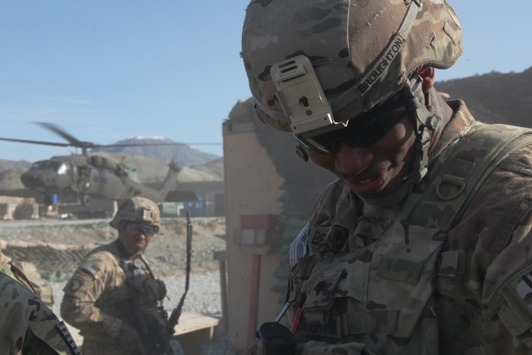 U.S. Army Spc. Elijah Broughton, right, shields his face as a UH-60 Black Hawk helicopter lands before an Afghan Border Patrol outpost assessment on Forward Operating Base Joyce in Kunar province, Afghanistan, Feb. 10, 2013. Broughton is assigned to the 101st Airborne Division's Security Force Advise and Assist Team Gambit, 2nd Battalion, 327th Infantry Regiment, 1st Brigade Combat Team.