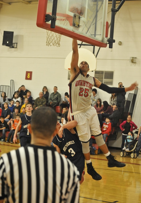 Jaylen, co-captain, Quantico Middle/High School Warriors, jumps over an opponent while attempting a shot during a home game against the Holy Family Academy Vendeens on Feb. 15. The Warriors won the game, 59-46.