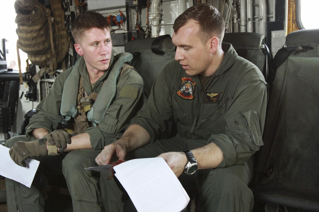 U.S. Marines Capt. Travis E. Keeney, left, and Capt. Christopher B. Churchill review flight plans at Utapao, Kingdom of Thailand, Feb. 14 during exercise Cobra Gold 2013. The two pilots were coordinating flight plans before conducting a flyby during an amphibious assault demonstration. U.S. Marines and sailors from the 31st Marine Expeditionary Unit executed the demonstration alongside Royal Thai Marines. CG 13, in its 32nd iteration, is a multinational exercise that promotes regional prosperity, security and cooperation among partner militaries. Keeney is an MV-22 pilot with Marine Medium Tiltrotor Squadron 265, Marine Aircraft Group 36, 1st Marine Aircraft Wing, III Marine Expeditionary Force. Churchill is a CH-53E Super Stallion helicopter pilot with Marine Medium Helicopter Squadron 262, MAG-36.