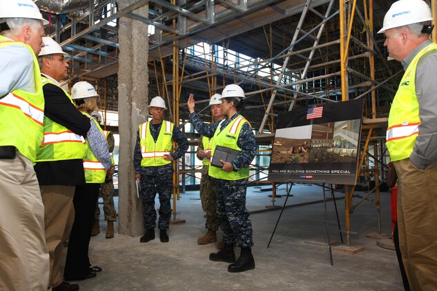 Lt. Cmdr. Angela M. Webster, the health facility planning/ projects officer for Navy Medicine West Camp Pendleton Detachment, explains the project development to the Congressional Delegation Miller during a tour through the construction of the new Camp Pendleton Naval Hospital, Feb. 16.