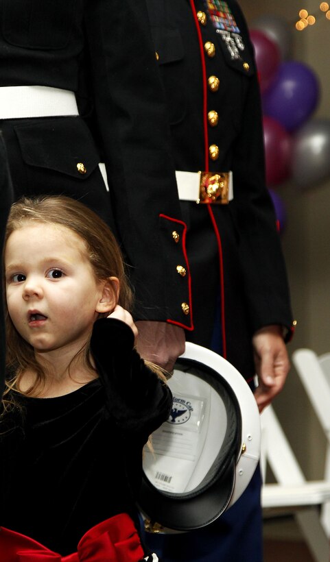 A young girl stands next to her father at the Combat Center's Father Daughter Dance Feb. 8, at Building 1707. There was no specific dress code so fathers dressed up in a variety of outfits, including their favorite uniforms or business suits. Nearly 400 father-daughter couples attended the dance.