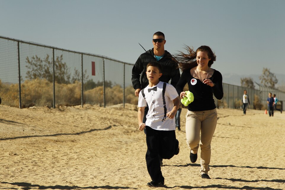 Marines with MCCES run with students of Condor Elementary School during the kids’ P.E. class Feb. 6 as part of the Adopt-A-School Program. The Marines were encouraging the kids during their usual run, preparing them for the State Fitness Test.