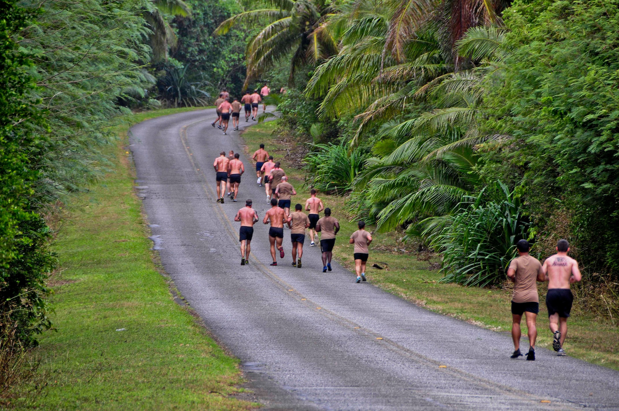 Members from U.S. Navy Explosive Ordnance Disposal Mobile Unit 5 run Sanders Slope at Andersen Air Force Base, Guam, Feb. 15, 2013. The EODMU5 members and their families took on the challenge of Sanders Slope, from Tarague Beach to the top of the hill and back, as part of their family and morale day. (U.S. Air Force photo by Airman 1st Class Marianique Santos/Released)
