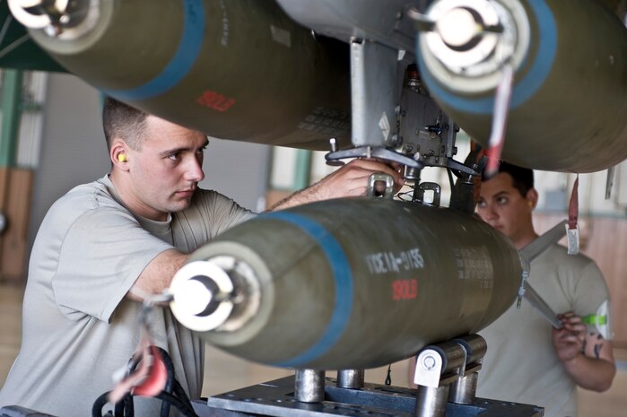 Staff Sgt. Kevin Knight and Senior Airman Ian Carter, 757th Aircraft Maintenance Squadron weapons load crew members, load a MK-82 onto an A-10 Thunderbolt II Feb.15, 2013, at Nellis Air Force Base, Nev.  Weapons loaders participate in quarterly load crew competitions to keep airmen sharp and to recognize superior performers. (U.S. Air Force photo by Senior Airman Matthew Lancaster)