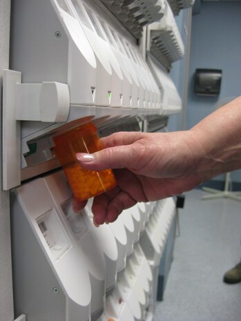 Penny Cervantes, 99th Medical Group pharmacy technician, fills a prescription with an automated dispenser Feb. 19, 2013, at the Mike O’Callaghan Federal Medical Center, Nellis Air Force Base, Nev. The main pharmacy is refilling certain prescriptions that have run out before the patients’ next appointment. (U.S. Air Force photo by Caitlin Kenney)