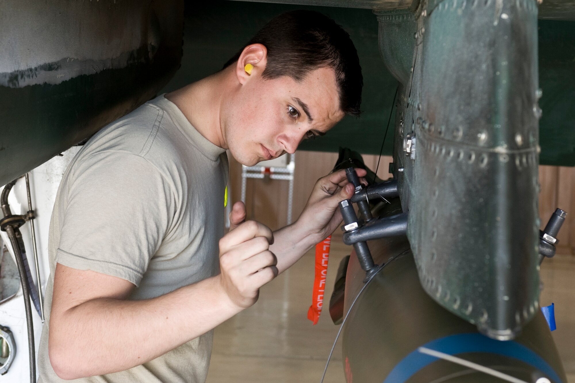 Senior Airman Ian Carter, 757th Aircraft Maintenance Squadron weapons load crew member, loads a GBU-12 Paveway II onto an A-10 Thunderbolt II Feb.15, 2013, at Nellis Air Force Base, Nev. Weapons loaders load various types of munitions to the specific aircraft to which they are assigned. (U.S. Air Force photo by Senior Airman Matthew Lancaster)