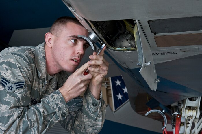 Senior Airman Michael Schena, 57th Maintenance Group weapons load crew member, prepares an F-15 Eagle to load an AIM-120C missile Feb. 15, 2013, at Nellis Air Force Base, Nev. Weapons loaders have many duties that include loading, unloading, positioning, and preparing munitions. (U.S. Air Force photo by Senior Airman Matthew Lancaster)
