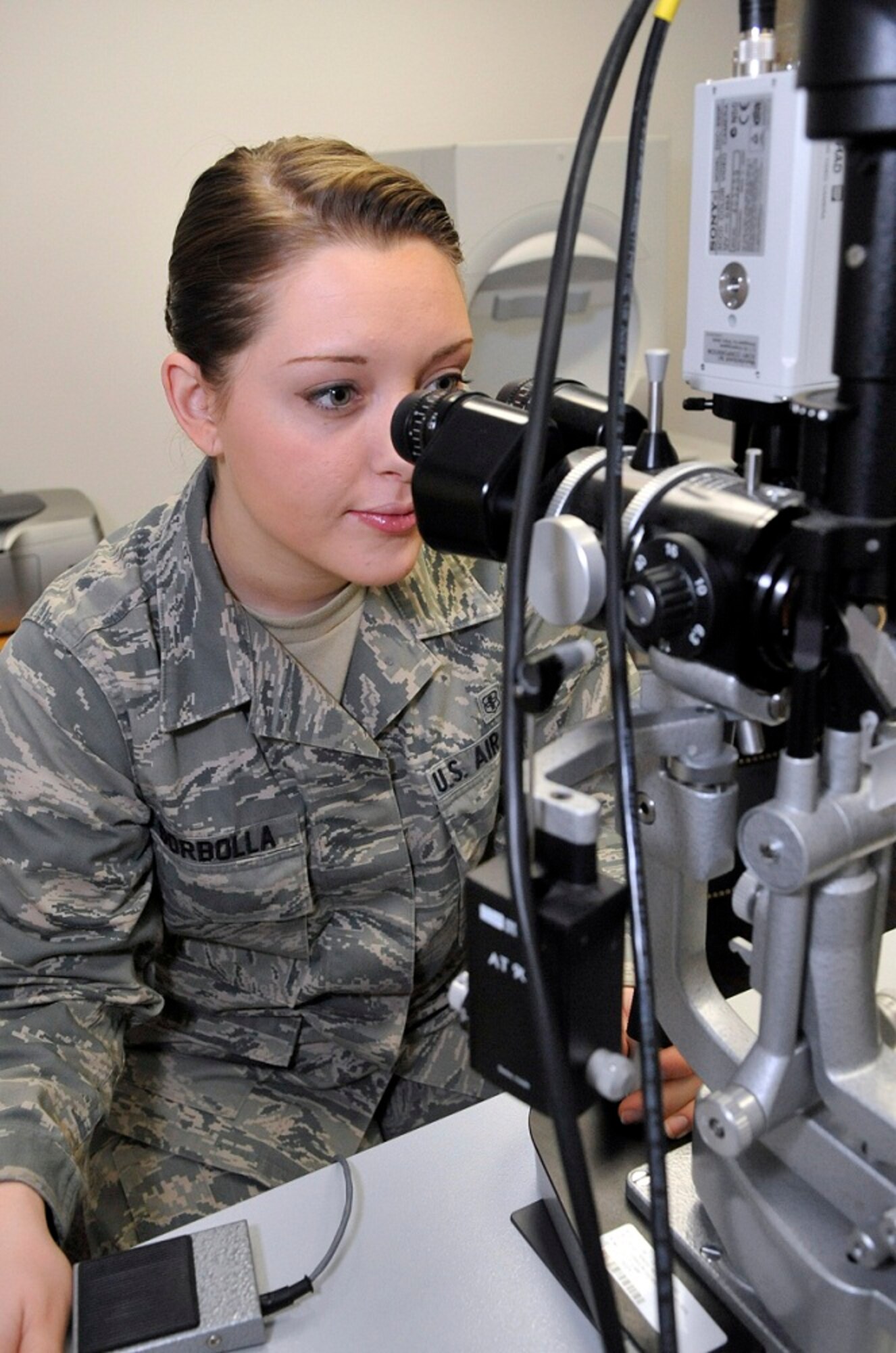 Airman 1st Class Sylvian Zwynenburg, 87th Aerospace Medicine Squadron optometry technician, uses a Slit Lamp to take pictures of the retina, optic nerve head and macula during a routine eye exam Feb. 8, 2013, at the Optometry Clinic at Joint Base McGuire-Dix-Lakehurst, N.J. The 87th AMDS supports the operational Air Force by enhancing, the health of its people, ensuring a fit force, preventing disease and injury. Zwynenburg  hails from Queensbury, N.Y.  (U.S. Air Force photo by Wayne Russell/Released)