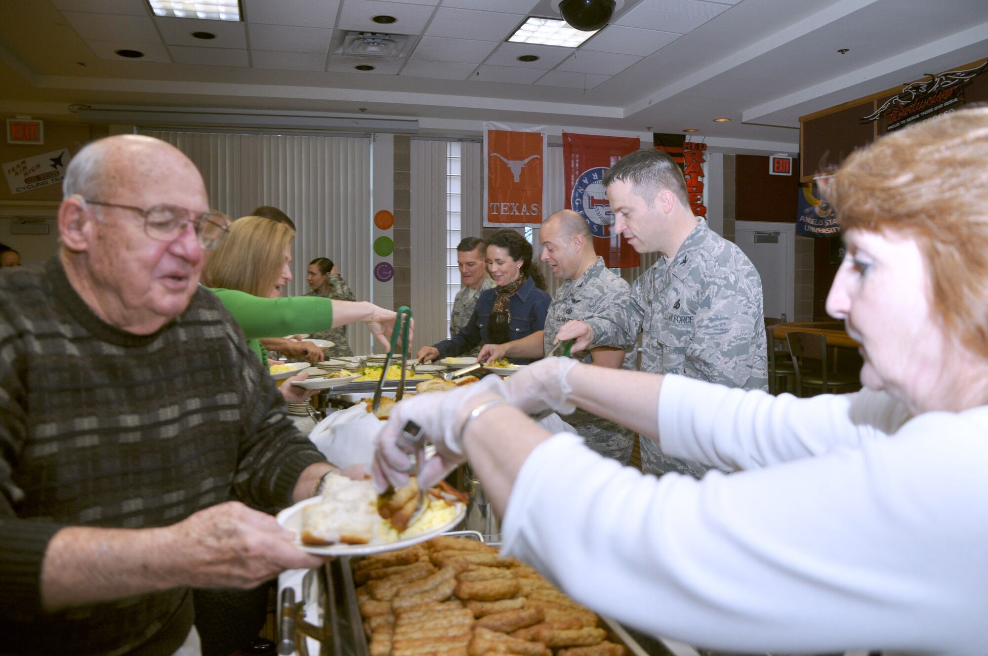 GOODFELLOW AIR FORCE BASE, Texas—Charlie Powell, former 17th Training Wing Commander, receives a serving of sausage during the National Prayer Breakfast at the Event Center, Feb. 12. The annual event marks a time for the nation and all its different religions to come together to pray for the well being of our country’s leaders. (U.S. Air Force photo/Airman Jessica Keith) 