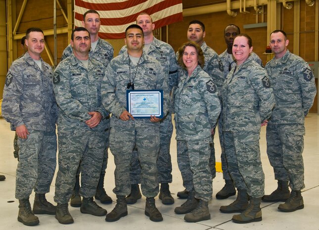 Members of the Nellis First Sergeants' Association present the Diamond Sharp Award to Airman 1st Class Christian Rodriguez, 57th Aircraft Maintenance Squadron crew chief, Feb. 14, 2013, at Nellis Air Force Base, Nev. Rodriguez played a critical role in the F-22 Raptor oxygen modification system, volunteers actively at an animal shelter in Las Vegas and continues to stride towards his Community College of the Air Force degree, recently completing 12 credit hours. (U.S. Air Force photo by Senior Airman Brett Clashman)