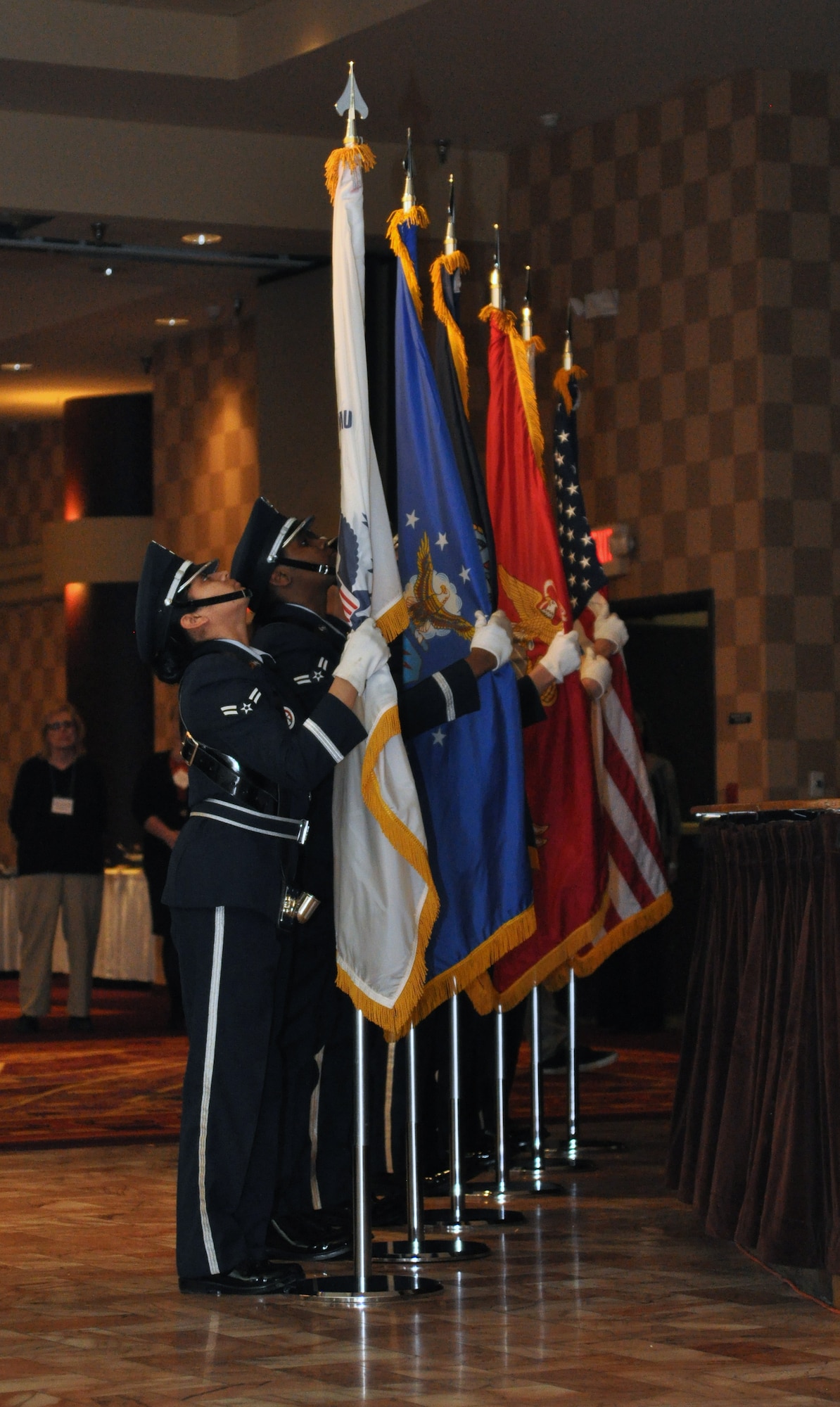 The Offutt Honor Guard posts the colors from each branch of military service as well as the American flag to mark the beginning of the inaugural Salute to America’s Heroes dinner at the Omaha Ramada Inn Feb. 16. Attendees were given two nights at a hotel, tickets to the Durham Museum, Joslyn Art Museum and Omaha Children’s Museum, and passes to the Coco Key indoor water resort all for free thanks to the Wounded Warrior Family Support Program. (Photo by Ryan Hansen)