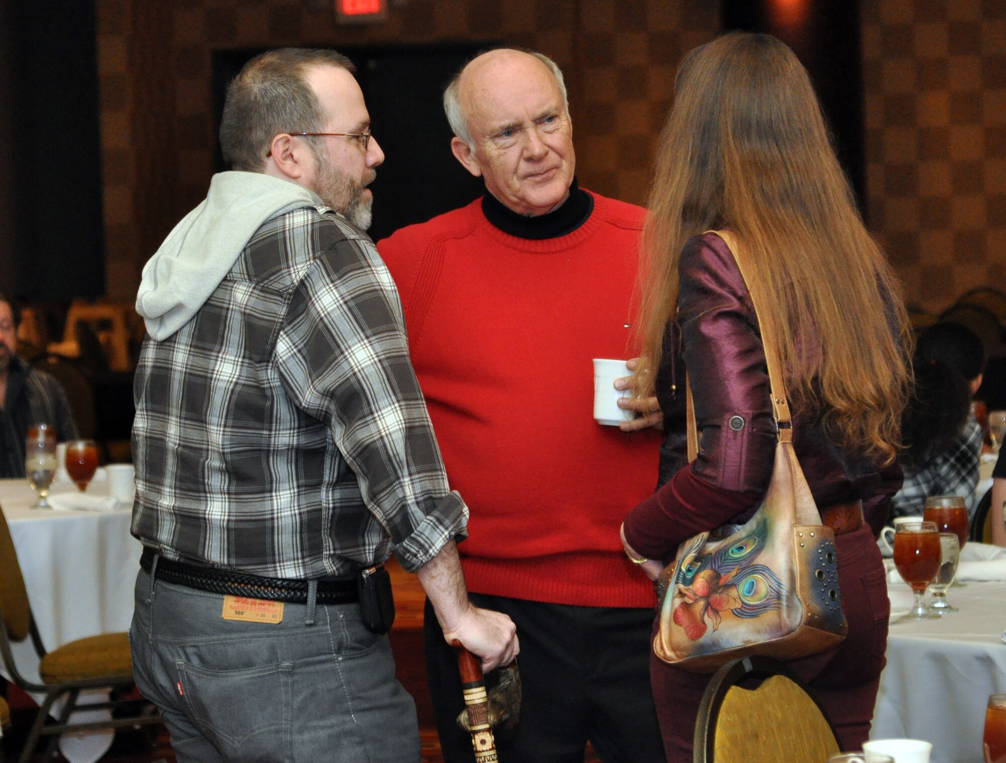 From left to right; James George, a retired Air Force captain and Purple Heart recipient, Omaha Mayor Jim Suttle, and Robyn George, talk before the inaugural Salute to America’s Heroes dinner at the Omaha Ramada Inn Feb. 16. The event brought together more than 50 wounded warriors and their families for the weekend. (Photo by Ryan Hansen)