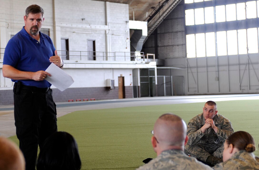 Dion Harris, 28th Security Forces Squadron lead instructor, briefs Airmen from the 28th Mission Support Group on how to deal with an active shooter situation during a 28th MSG deployment readiness exercise in the Pride Hangar on Ellsworth Air Force Base, S.D., Feb. 14, 2013. During the session, Airmen were instructed to seek safe shelter and notify authorities if possible. (U.S. Air Force photo by Airman Ashley J. Thum/Released)