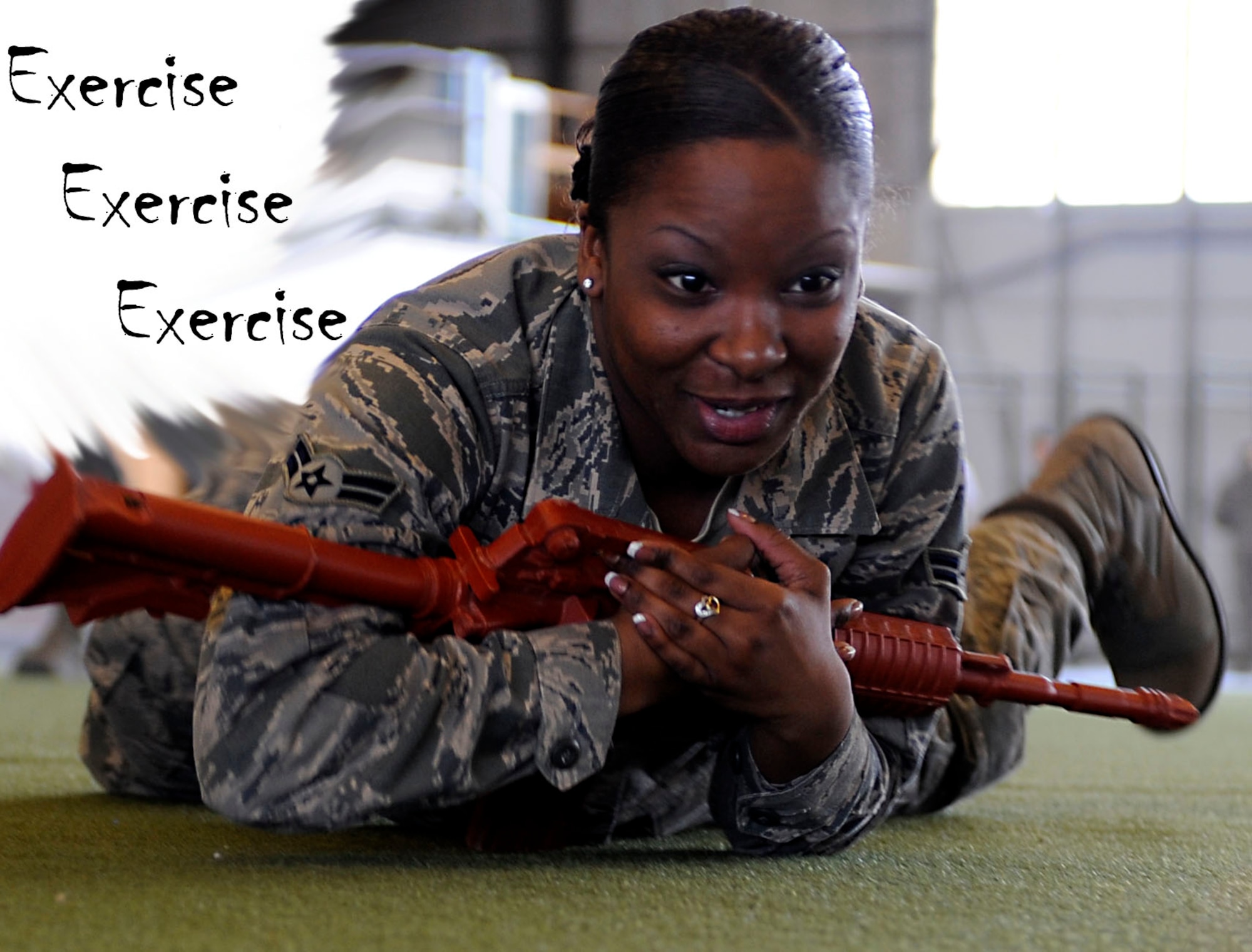 Airman 1st Class Wintera Jones, 28th Force Support Squadron personnel technician, practices high crawling during a 28th Mission Support Group deployment readiness exercise in the Pride Hangar at Ellsworth Air Force Base, S.D., Feb. 14, 2013. The 28th Security Forces Squadron hosted the exercise which focused on cover and concealment, M-4 carbine and M-9 handgun familiarization and what to do in the event of an active shooter scenario. (U.S. Air Force photo illustration by Airman Ashley J. Thum/Released)