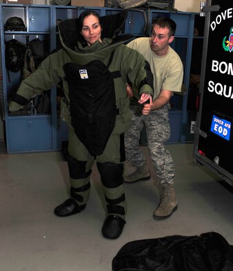 Master Sgt. Jennifer Allara, 436th Civil Engineer Squadron, Explosive Ordinance Disposal team leader, puts on a bomb suit while Staff Sgt. Jared Hess, 436th CES, NCOIC of EOD equipment, assists Feb. 14, 2013, at the EOD building on Dover Air Force Base, Del. Allara has been in the Air Force for 17 years. (U.S. Air Force photo by Tech. Sgt. Chuck Walker)