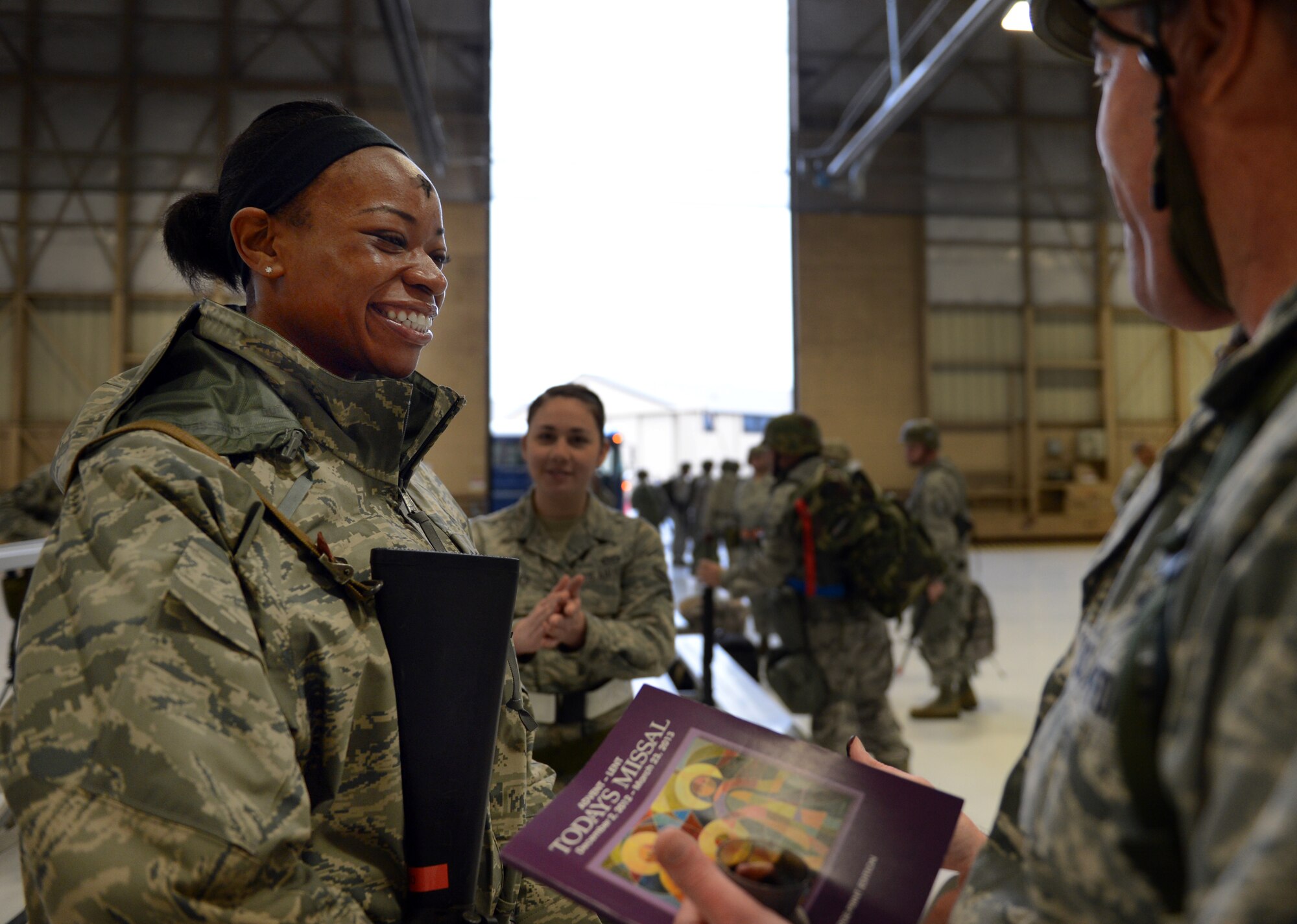 U.S. Air Force Senior Airman Cymantha Lewis, 20th Civil Engineer Squadron operations manager, talks with Chaplain Richard Fitzgerald, 20th Fighter Wing Chaplain, during exercise Weasel Victory 13-03 at Shaw Air Force Base, S.C., Feb. 13, 2013. Chaplains from Palmetto Chapel on base participated in the exercise to ensure that players were able to partake in Ash Wednesday. (U.S. Air Force photo by Senior Airman Tabatha Zarrella/Released)
