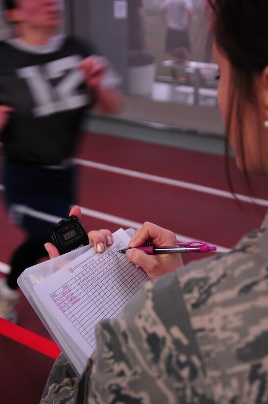 Niles, Ohio—U.S. Air Force Senior Airman Kate Smith, Physical Training Leader, 910th Airlift Wing Medical Squadron, records completed laps and elapsed time for Air Force personnel performing Fit 2 Fight examinations Sunday, February 03, 2013 at the Niles Wellness Center. Individuals are required to test either annually or biannually based on their results. U.S. Air Force photo by Senior Airman Ron Dombkowski