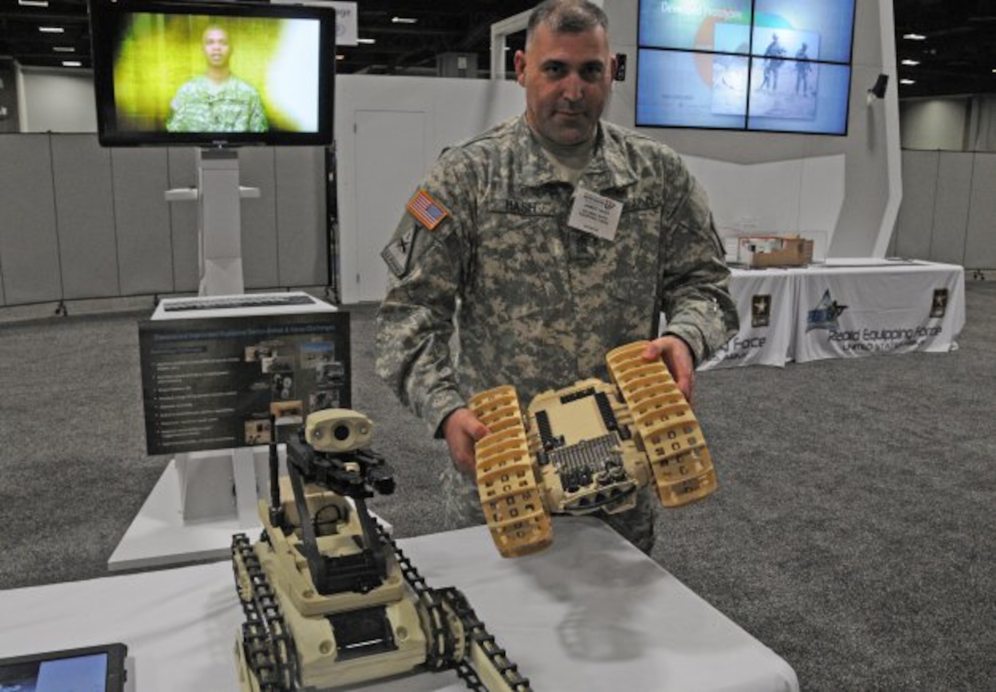 Sgt. Maj. James Hash shows a Rapid Equipping Force procured Dragon Runner, operated by Soldiers remotely in Afghanistan for reconnaissance and counter improvised explosive device operations. (U.S. Army courtesy photo/Released)