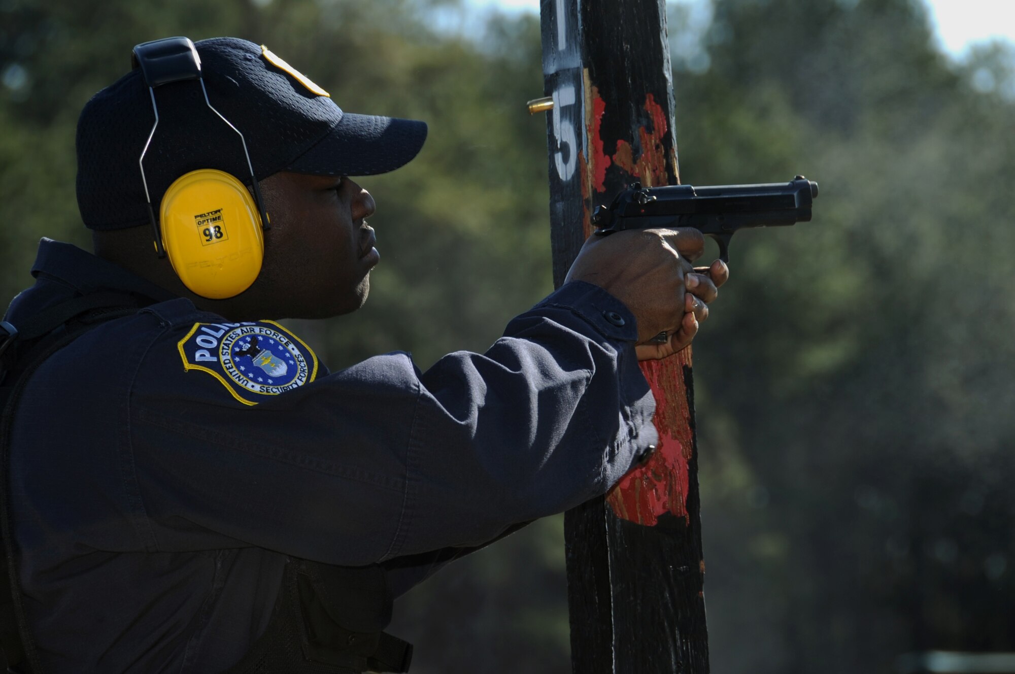 A Department of the Air Force police officer fires an M9 pistol at a target at the Bossier Parish Sheriff's Office firing range in Plain Dealing, La., Feb. 14. DAF officers are government employees who must go through rigorous and strict training, and must meet the physical, medical and weapon proficiency standards to be hired. DAF police officers must qualify in the M4 Carbine and M9 pistol annually. (U.S. Air Force photo/Airman 1st Class Benjamin Gonsier)
