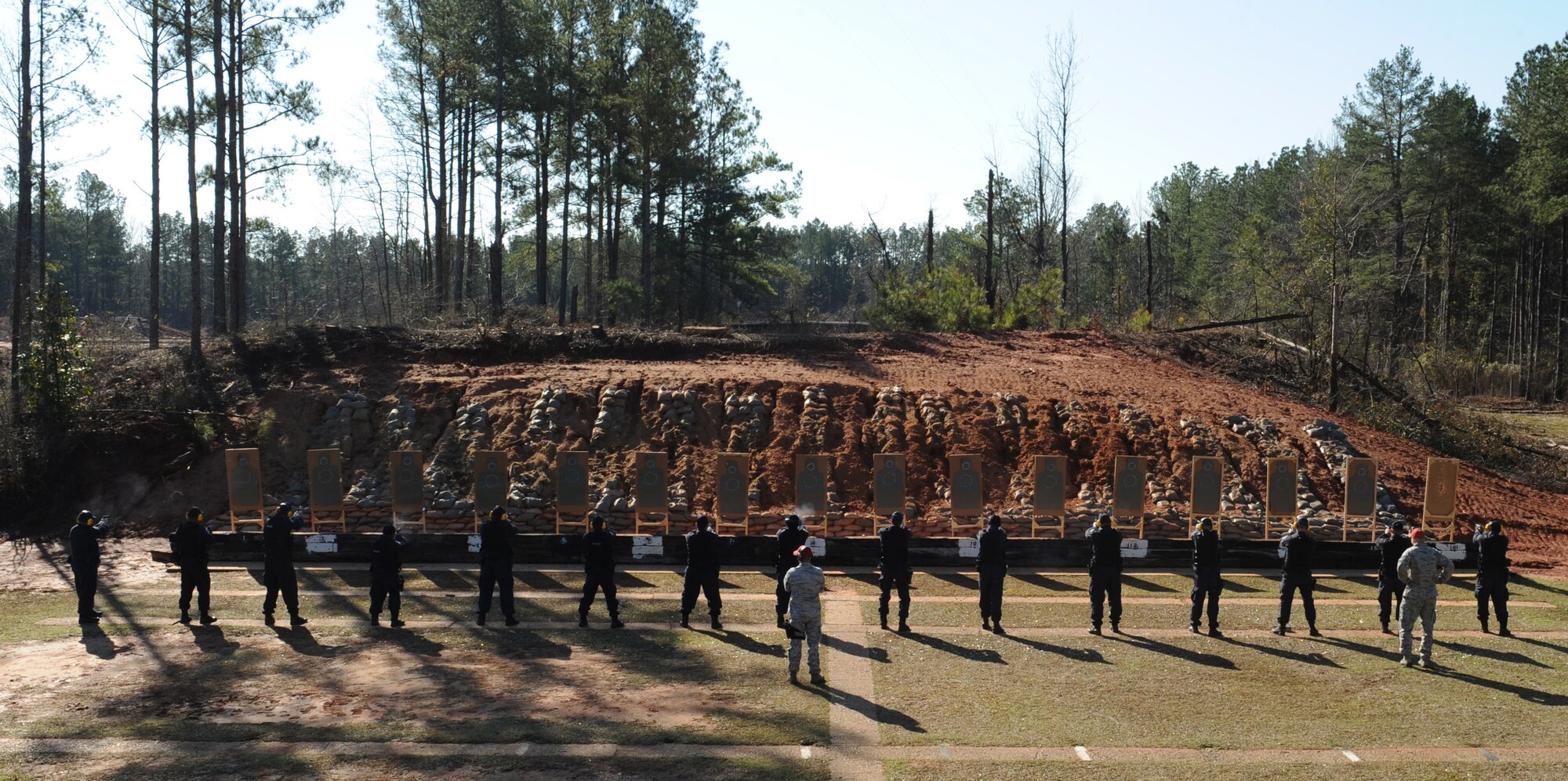 Department of the Air Force police officers fire their M9 pistols at the Bossier Parish Sheriff's Office firing range in Plain Dealing, La., Feb. 14. DAF officers are government employees who must go through rigorous and strict training, and must meet the physical, medical and weapon proficiency standards to be hired. DAF police officers must qualify in the M4 Carbine and M9 pistol annually. (U.S. Air Force photo/Airman 1st Class Benjamin Gonsier) 
