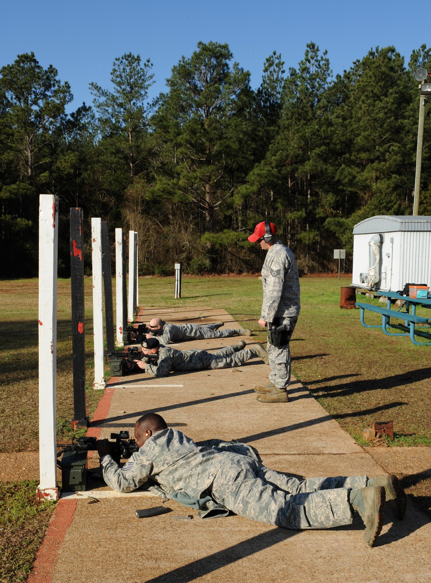 Staff Sgt. Nicholas Niles, 2nd Security Forces Squadron combat arms, watches security forces Airmen fire their M4 Carbines at the Bossier Parish Sheriff's Office firing range in Plain Dealing, La., Feb. 14. Combat Arms instructors are responsible for teaching Airmen how to properly handle and maintain their weapons. (U.S. Air Force photo/Airman 1st Class Benjamin Gonsier)
