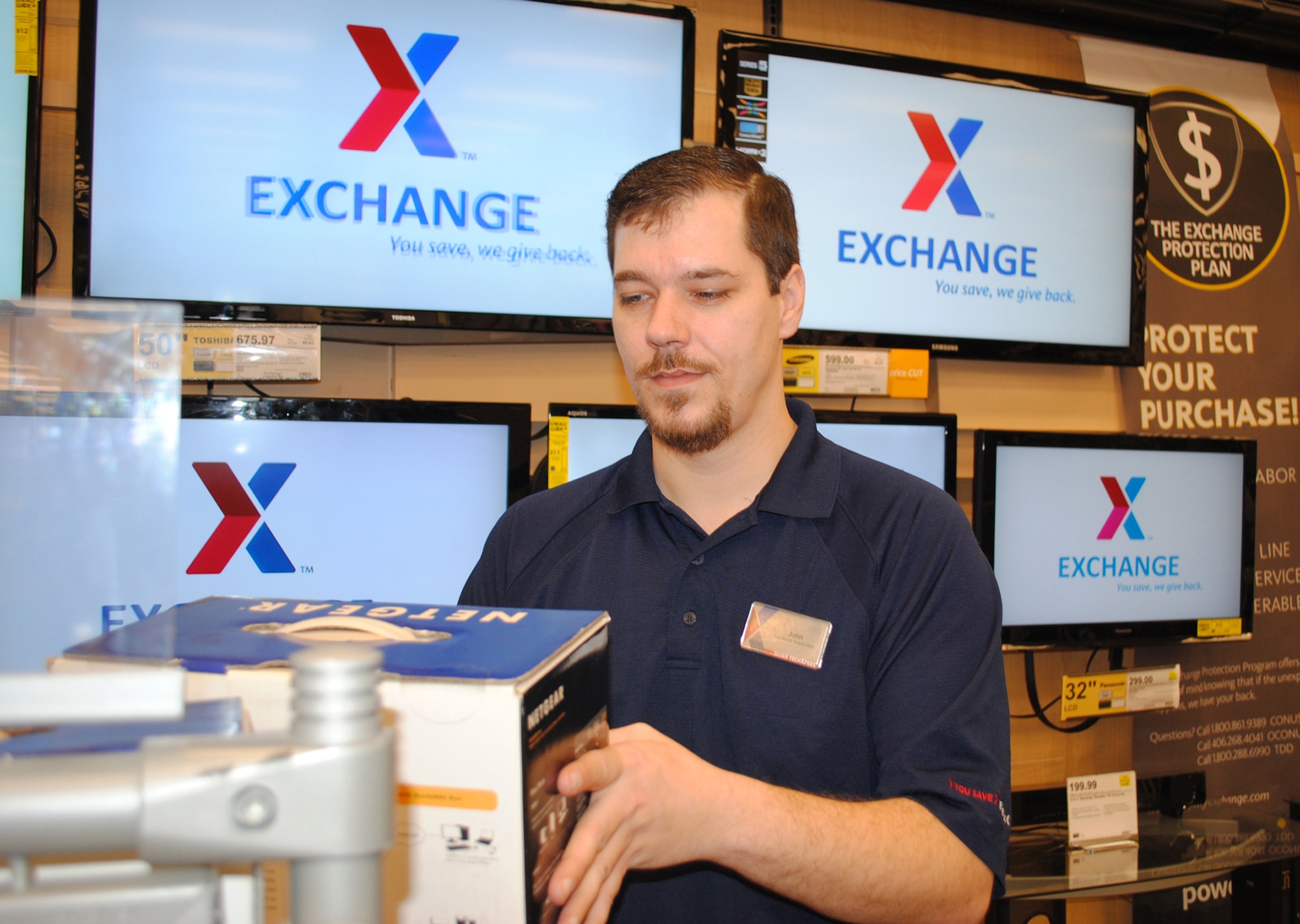 John Rouse, a hardlines (electronics department) supervisor at the Army and Air Force Exchange Service store, organizes electronic products on Feb. 15, 2013 at Grand Forks Air Force Base, N.D. Rouse was named the base’s Warrior of the Week for the third week of February 2013. (U.S. Air Force photo/Senior Airman Luis Loza Gutierrez) 