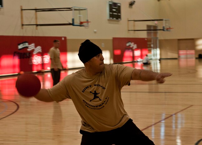 Jake Quinories, 99th Civil Engineer Squadron heavy equipment operator, throws a dodge ball in a match between the Top 3 , a senior non-commissioned officer organization, and the 5/6, a non-commissioned officer organization, Feb. 15, 2013, at Nellis Air Force Base, Nev.  The first match between the two groups ended in a 2-2 draw. (U.S. Air Force photo by Senior Airman Daniel Hughes)  