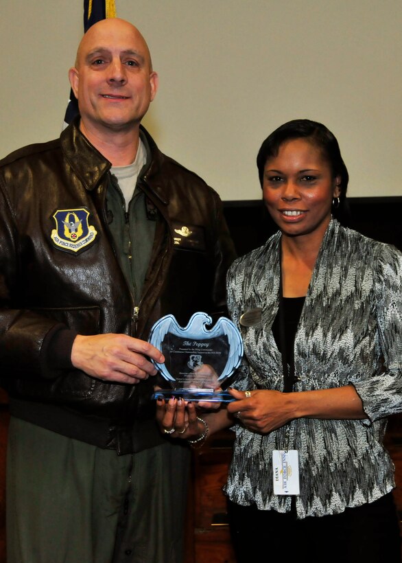 Diana Yelder of the 919th Force Support Squadron receives the 919th Special Operations Wing’s Peppey Award from Col. Andy Comtois, 919th SOW commander, during a recent ceremony at Duke Field, Fla.  The Peppey Award recognizes the wing’s outstanding non-reservist civilian employee of the quarter. Yelder is the FSS lodging manager. (U.S. Air Force photo/Tech. Sgt. Jasmin Taylor)