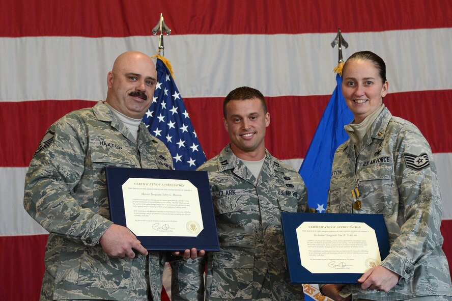 U.S. Air Force Master Sgt. Terry Haxton, 20th Aircraft Maintenance Squadron, 79th Aircraft Maintenance Unit lead production superintendent, and Tech Sgt. Sue Haxton, NCO in charge for the 39th Medical Support Squadron, receive their certificates of retirement at Shaw Air Force Base, S.C., Feb. 15, 2013.  After more than 20 years of service in the United States Air Force, both Haxtons retired together. (U.S. Air Force photo by Airman 1st Class Nicole Sikorski/Released)