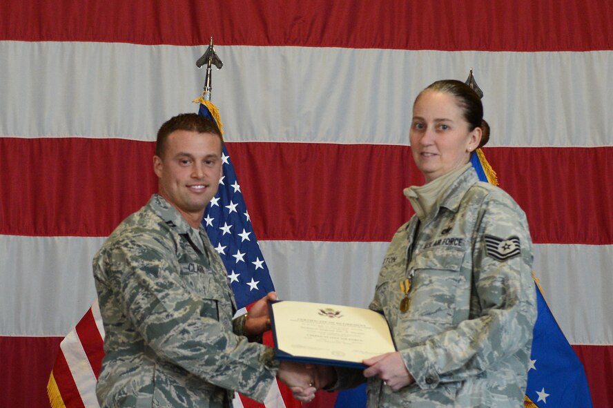 U.S. Air Force Tech Sgt. Sue Haxton, NCO in charge for the 39th Medical Support Squadron, receives a certificate of retirement at Shaw Air Force Base, S.C., Feb 15. 2013.  After 20 years of service in the United States Air Force, Haxton retired next to her husband, Master Sgt. Terry Haxton, 20th Aircraft Maintenance Squadron, 79th Aircraft Maintenance Unit lead production superintendent. (U.S. Air Force photo by Airman 1st Class Nicole Sikorski/Released)