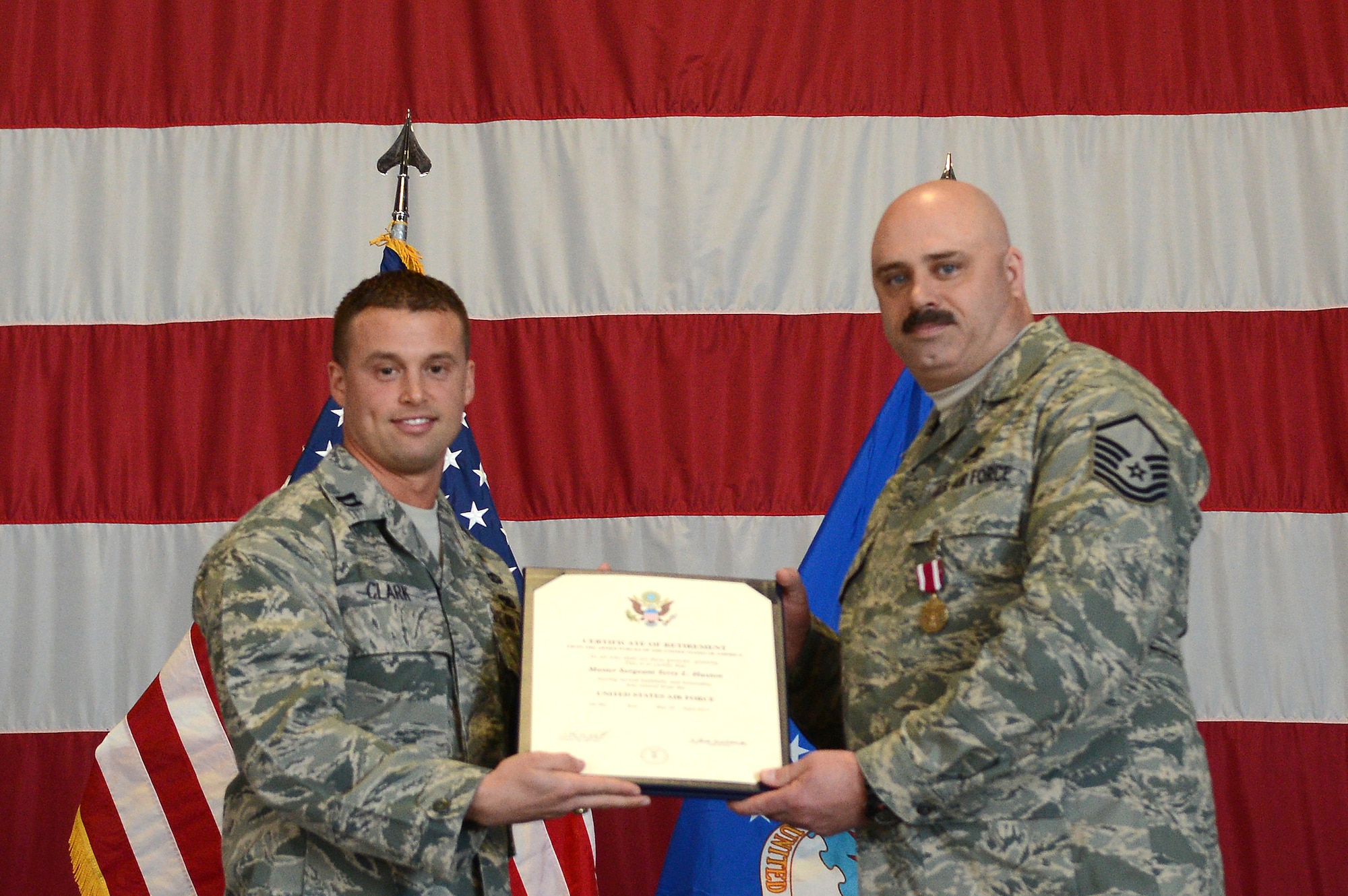 U.S. Air Force Master Sgt. Terry Haxton, 20th Aircraft Maintenance Squadron, 79th Aircraft Maintenance Unit lead production superintendent, receives a certificate of retirement at Shaw Air Force Base, S.C., Feb. 15, 2013.  After 24 years of service in the United States Air Force, Haxton retired next to his wife Tech. Sgt. Sue Haxton, NCO in charge for the 39th Medical Support Squadron. (U.S. Air Force photo by Airman 1st Class Nicole Sikorski/Released)
