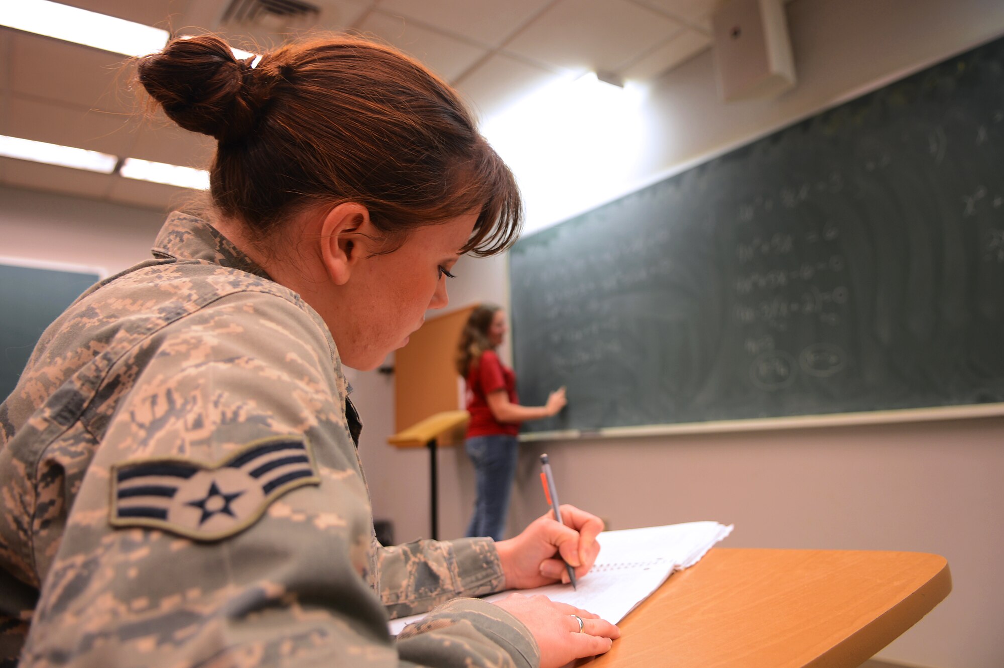 U.S. Air Force Senior Airman Ashley Casto, 609th Air Operations Center, Detachment 1, air tasking order technician, takes notes during an algebra class at University of South Carolina Sumter, S.C., Feb. 13, 2013.  Casto is enrolled at USC and taking classes to work towards attaining her Community College of the Air Force degree. (U.S. Air Force photo by Airman 1st Class Nicole Sikorski/Released)