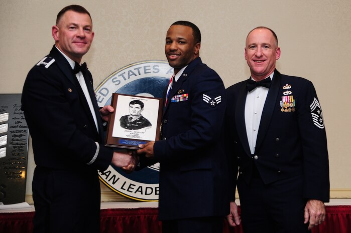 Colonel Richard McComb, Joint Base Charleston commander, and Chief Master Sgt. Earl Hannon, 628th Air Base Wing command chief, present the John L. Levitow Award to Senior Airman Marcus Broughton, from the 437th Aircraft Maintenance Squadron, during the Airman Leadership School Class graduation Feb. 14, 2013, at Joint Base Charleston - Air Base, S.C. The Levitow award is given for a student's exemplary demonstration of excellence, both as a leader and a scholar.