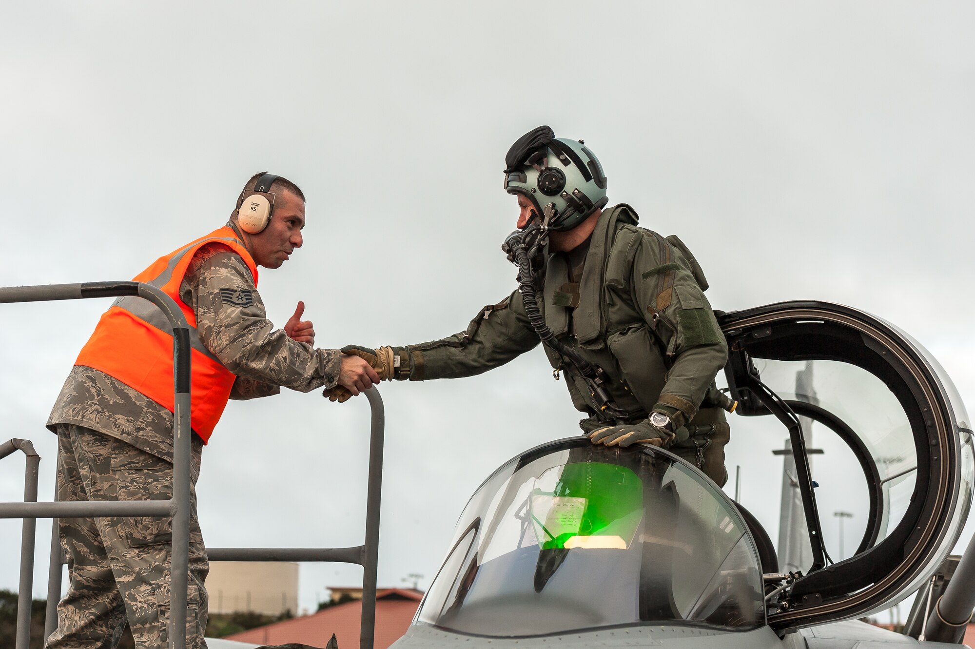 Staff Sgt. Gustavo Cifuentes, 65th Operations Support Squadron Transient Alert / Crash Recovery technician, welcomes a Swedish Air Force pilot returning from the Red Flag aerial combat training exercise at Nellis Air Force Base, Nev., Feb. 5. Cifuentes, an F-16 crew chief, has been selected to join the Air Force Thunderbirds at Nellis AFB.  Upon joining the team, he will complete the Thunderbirds’ “21-Day Program,” a rigorous training and orientation period. (Photo by Lucas Silva)