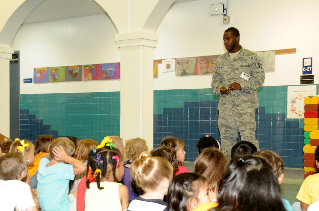 ANDERSEN AIR FORCE BASE, Guam – Tech. Sgt. Jeremy Harris, 36th Medical Operations Squadron Dental Flight dental hygienist, explains the importance of good oral hygiene to children at Andersen Elementary School Feb. 15, 2013. The dental flight provided small group presentations to more than 800 children at the school as part of National Children’s Dental Health Month, observed annually in February. (U.S. Air Force photo by Airman 1st Class Adarius Petty/Released)