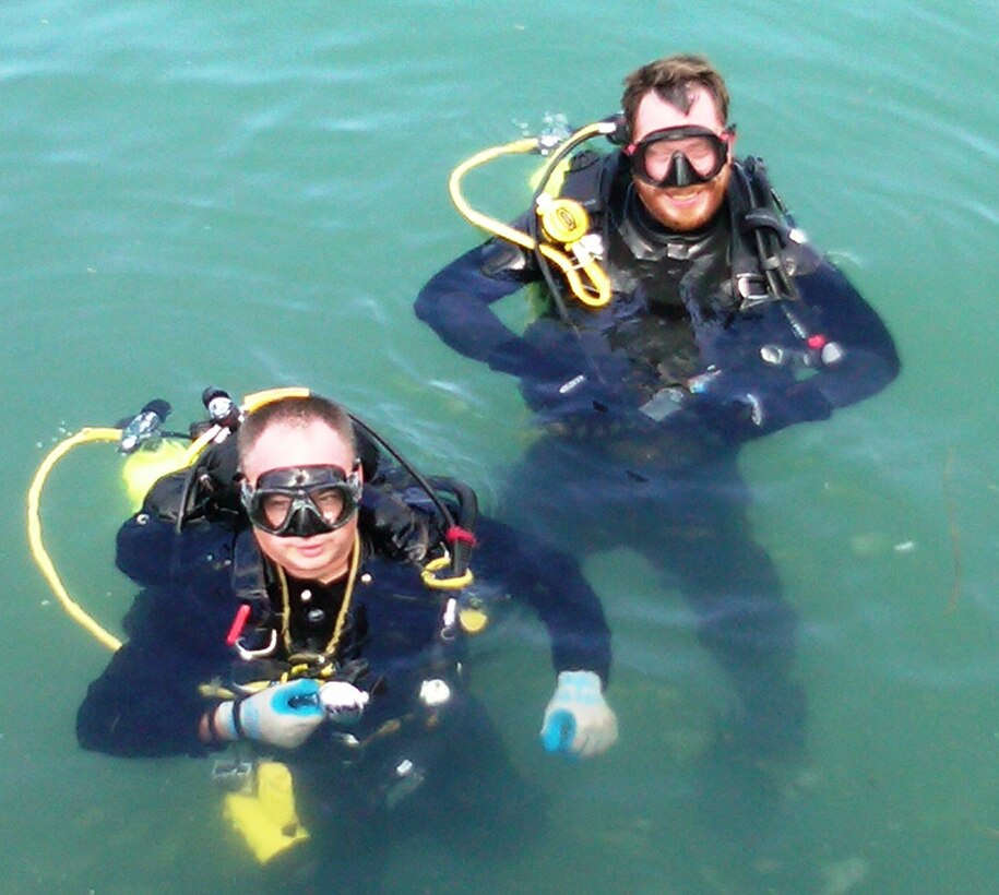 USACE Forward Response Dive/Survey Team members Steve England and Andrew Rapp await pick-up from a dive boat after completing an underwater evolution during their mission at Okinawa, Japan.