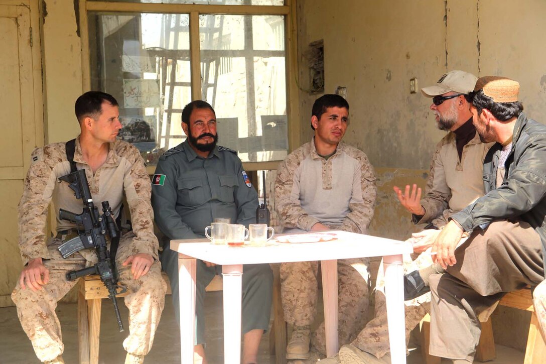 Captain Kyle Larish, the executive officer of Police Advisor Team 4, and 31-year-old native of Buffalo, New York, engages with the assistant district chief of police and other Afghan Uniformed Police during a patrol to the Kajaki Police Headquarters, Feb. 11. "(We) are advising their key staff members in their functional areas to coordinate their efforts with their higher headquarters," said 1st Lt. Chad Ernst, the fires officer and Joint Terminal Attack Controller with PAT-4. "We are trying to help them get the Afghan support they need in the correct format."