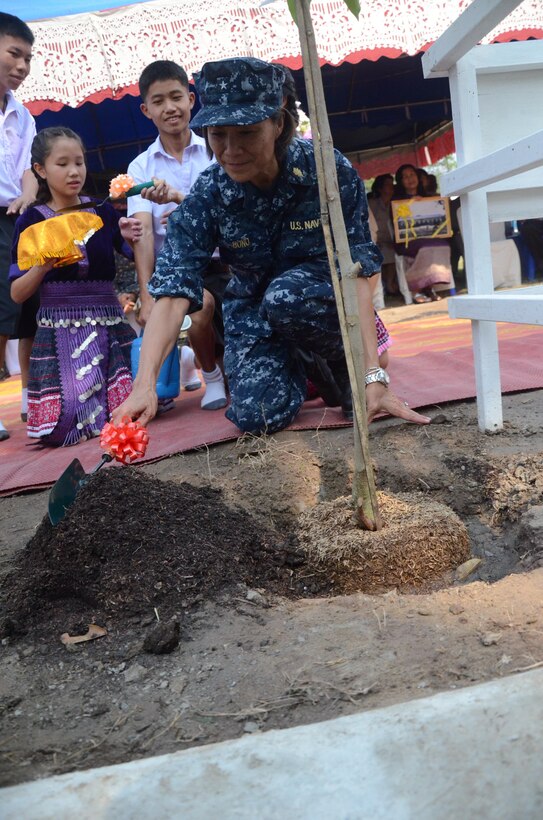 U.S. Navy Rear Adm. Raquel C. Bono, U.S. Pacific Command surgeon, plants a tree during the dedication ceremony of a multipurpose building at Ban Piang Elementary School in San Pa Tong district, Chiang Mai province, Kingdom of Thailand Feb. 18. During the ceremony, attendees celebrated the building constructed by multinational forces during an engineering civic assistance project, part of exercise Cobra Gold 2013. Cobra Gold, in its 32nd iteration, is designed to advance regional security by joining multinational forces together in partnership to solve regional challenges.