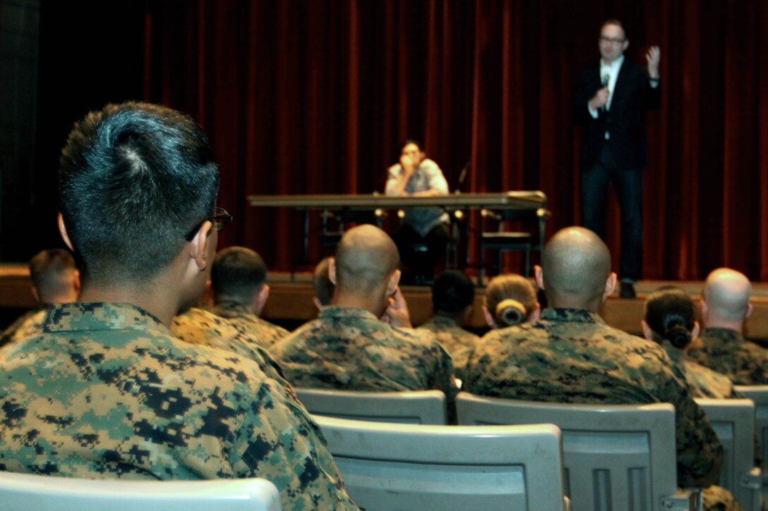 Marines wait for a one-man play titled “Rum and Vodka” to begin, as Bryan Dorries, the artistic director of the production, introduced Adam Driver, an actor who performed an excerpt from the monologue at the base theater Feb. 14.