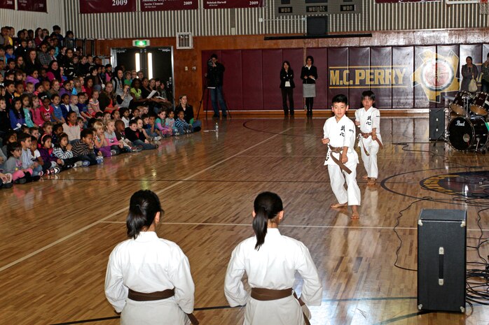 Students from the Shunan International Children's Club performs a karate demonstration during a cultural exchange event inside the Matthew C. Perry High School Gym here, Feb. 11, 2013.