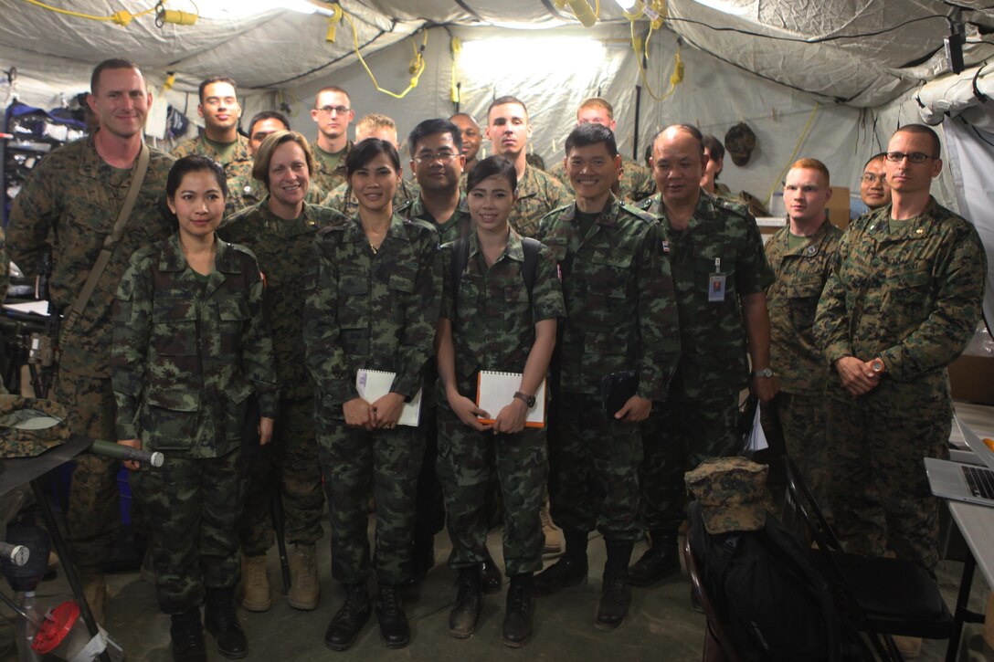 Medical personnel with 3rd Medical Battalion, III Marine Expeditionary Force, stand with medical representatives of the Royal Thai Army in the 31st Marine Expeditionary Unit's forward resuscitative surgical suite after conducting a tour here, Feb. 16. The RTA medical visit helps the U.S. medical staff set protocols for the treatment of any incoming Thai personnel during exercise Cobra Gold 2013. CG13, now in its 32nd iteration, allows U.S. forces to collaborate with partner countries to achieve mutual security goals, address shared concerns, and continue to develop and enhance relationships.