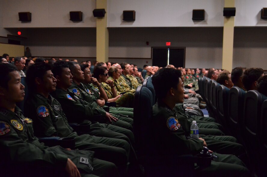 Participants from Cope North 13 watch a video highlighting the events from this year’s exercise during the closing ceremony at Andersen Air Force Base, Guam Feb. 15. Cope North 13 was conducted on Andersen, as well as the surrounding islands of Tinian and Saipan from Feb. 4-15. 72 aircraft from the U.S. Air Force, U.S. Navy, Japan Air Self-Defense Force and Royal Australian Air Force participated in the exercise. 1,897 personnel from 20 units assisted in allowing those aircraft to fly 823 sorties over the course of the two-week exercise. (U.S. Air Force photo by Staff Sgt. Alexandre Montes/Released)