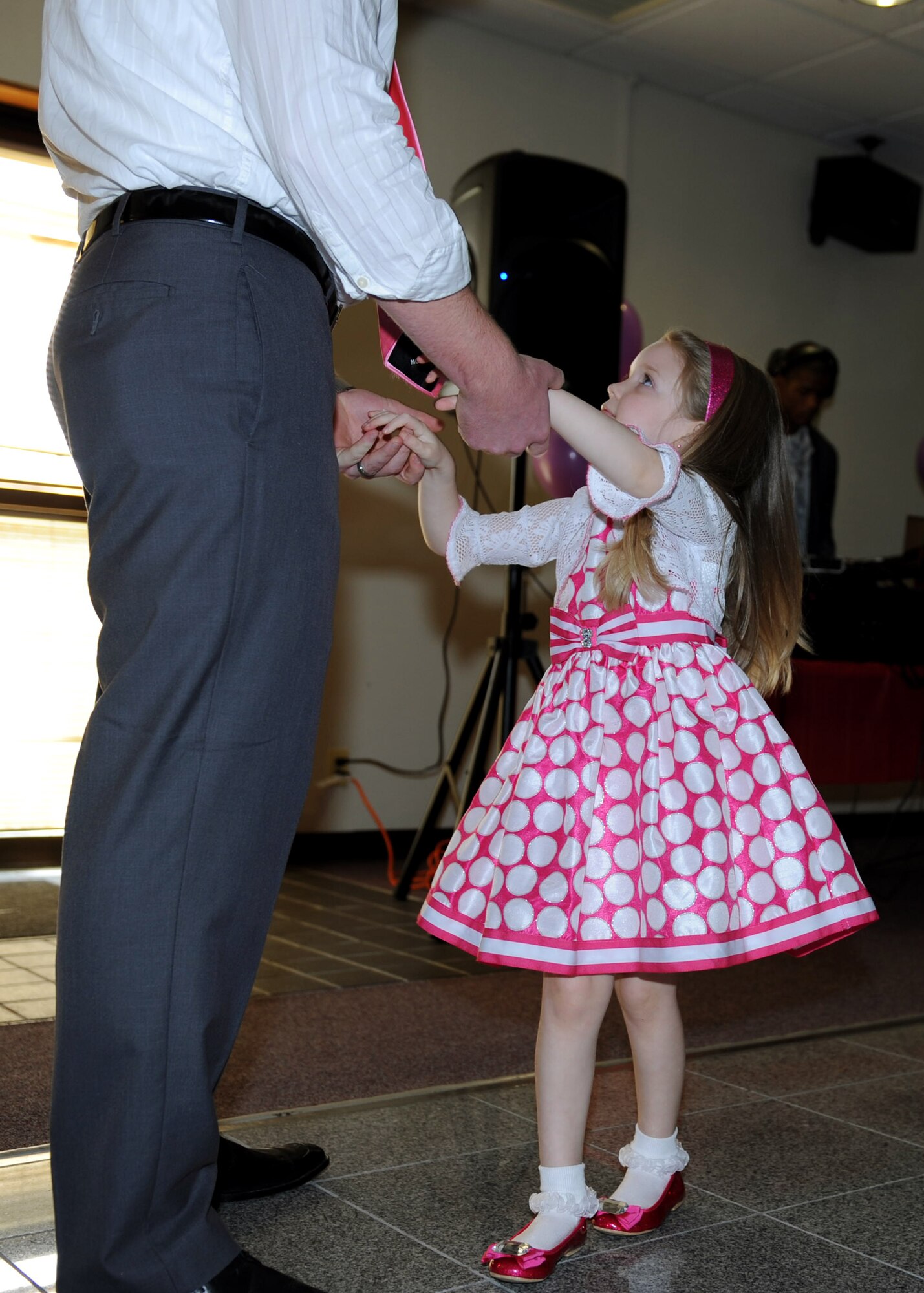A father dances with his daughter at the father-daughter dance on Kadena Air Base, Japan, Feb. 16, 2013. The event was the second father-daughter dance held by the Shogun Defenders, an 18th Security Forces Squadron booster club, and was held to bring fathers and daughters together for an afternoon of dancing, games and decorating cupcakes and other crafts. (U.S. Air Force photo/Airman 1st Class Hailey R. Davis)